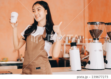 Young woman at barista school learning how to make espresso coffee. 139677273
