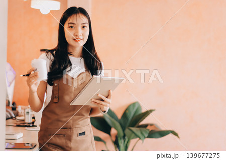 Young woman at barista school learning how to make espresso coffee. Young woman at barista school learning how to make espresso coffee. 139677275