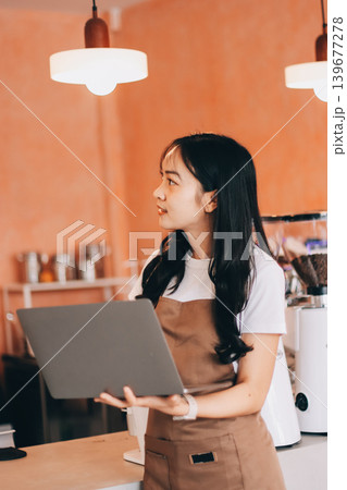 Young woman at barista school learning how to make espresso coffee. 139677278