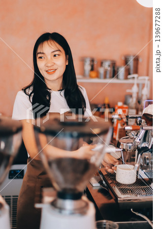 Young woman at barista school learning how to make espresso coffee. Young woman at barista school learning how to make espresso coffee. 139677288