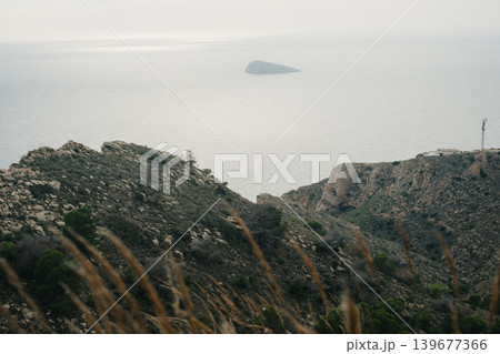 Serene coastal landscape with rocky cliffs and calm sea view Serene coastal landscape with rocky cliffs and calm sea view 139677366
