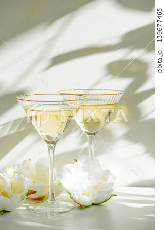 Champagne Glasses with White Peonies in Sunlight Champagne Glasses with White Peonies in Sunlight 139677465
