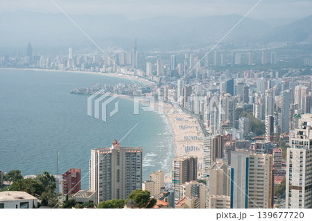 Scenic coastal city skyline with sandy beaches and modern skyscrapers Scenic coastal city skyline with sandy beaches and modern skyscrapers 139677720