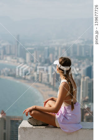 Woman enjoying scenic coastal city view from high vantage point 139677726