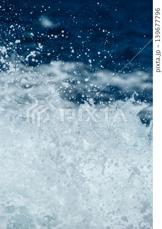 Dynamic ocean waves splashing under the blue sky with sunlight reflections Dynamic ocean waves splashing under the blue sky with sunlight reflections 139677796