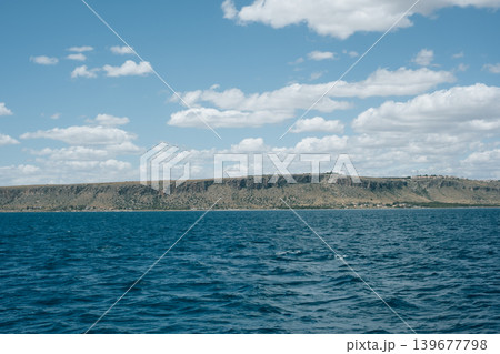 Scenic view of sevan lake and mountain plateau under a cloudy sky 139677798