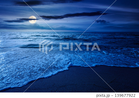 autumn vacation at the sea at night. full moon over beautiful seascape. calm waves wash the sandy beach. image with cloudy sky above horizon. mysterious background for fantasy or ads placement 139677922