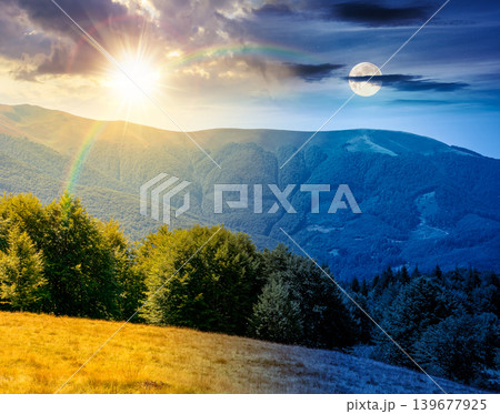 day meet night. mountainous landscape on autumn equinox. picturesque highland woods. sun and moon over grassy meadow. view of mountains with deciduous forest on a hill near pasture. harmony concept day meet night. mountainous landscape on autumn equinox. picturesque highland woods. sun and moon over grassy meadow. view of mountains with deciduous forest on a hill near pasture. harmony concept 139677925
