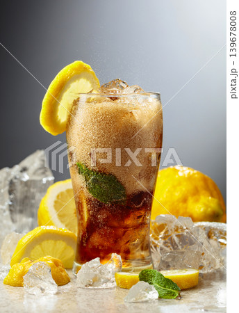 Cocktail Cuba Libre in a misted glass with lemon slices, ice and mint. Cocktail Cuba Libre in a misted glass with lemon slices, ice and mint. 139678008