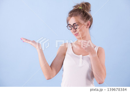 Elegant woman pretending wearing eyeglasses Elegant woman pretending wearing eyeglasses 139678384