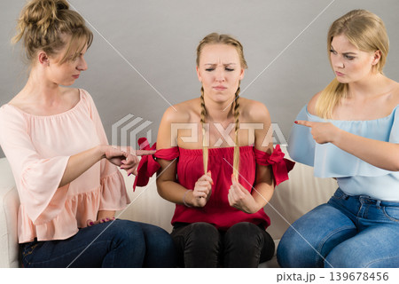 Woman being bullied by two females 139678456