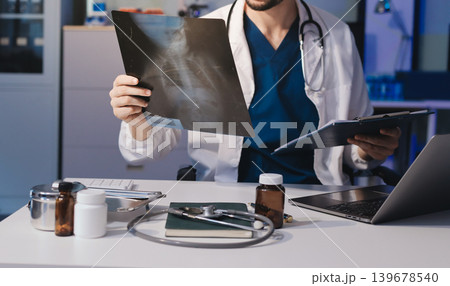 Man, doctor and laptop typing in healthcare research, communication or social media at office desk. Male medical expert working on computer in online search, browsing or chatting on tablet at clinic Man, doctor and laptop typing in healthcare research, communication or social media at office desk. Male medical expert working on computer in online search, browsing or chatting on tablet at clinic 139678540