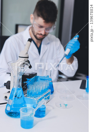 Lab technician experimenting in lab 139678814