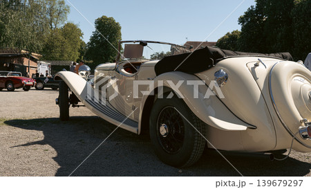 Berlin, Germany - May 2, 2026: Cream Vintage Roadster Rear Side View Berlin, Germany - May 2, 2026: Cream Vintage Roadster Rear Side View 139679297