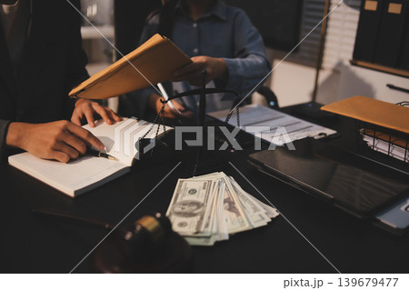 Lawyer explained to the client about the law that must be brought against the court case. Lawyer explained to the client about the law that must be brought against the court case. 139679477