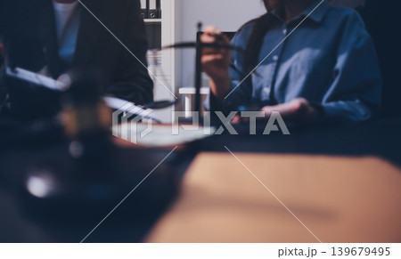 Lawyer explained to the client about the law that must be brought against the court case. Lawyer explained to the client about the law that must be brought against the court case. 139679495