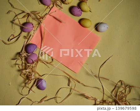 Easter display with chocolate eggs and straw blue background 139679598