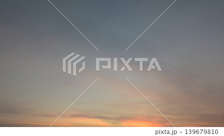 Beautiful minimalist background photography captures dawn sky texture. Soft pastel orange clouds float beneath a dark gradient dawn atmosphere, creating a peaceful natural scene for designs. Beautiful minimalist background photography captures dawn sky texture. Soft pastel orange clouds float beneath a dark gradient dawn atmosphere, creating a peaceful natural scene for designs. 139679810