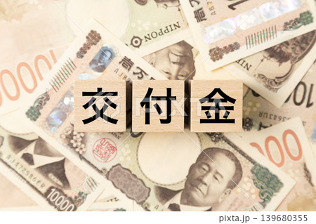 「交付金」と書かれたブロックとたくさんの一万円札 「交付金」と書かれたブロックとたくさんの一万円札 139680355