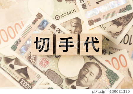 「切手代」と書かれたブロックとたくさんの一万円札 139681350