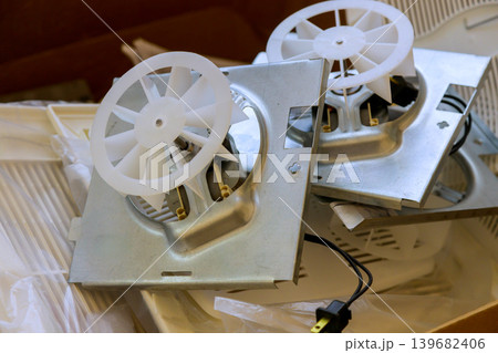 Metal fans parts placed on top of each other in messy workspace during routine cleanup in garage Metal fans parts placed on top of each other in messy workspace during routine cleanup in garage 139682406