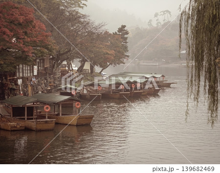 A peaceful collection of Japanese autumn landscapes featuring colorful maple trees, traditional temples, bamboo forests, and serene garden paths. These images capture the calm beauty of nature, warm 139682469