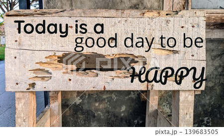 A cheerful quote, Today is a good day to be happy, written on a rustic, weathered wooden sign, embodying positive vibes. A cheerful quote, Today is a good day to be happy, written on a rustic, weathered wooden sign, embodying positive vibes. 139683505