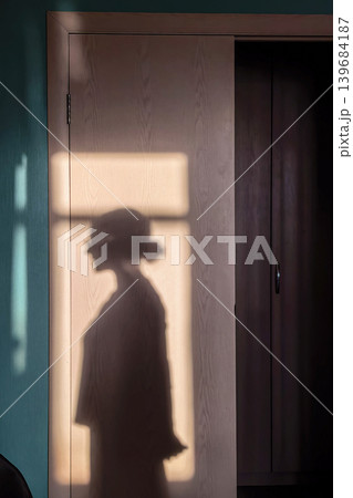 Human Shadow Silhouette On Interior Wall At Sunset 139684187
