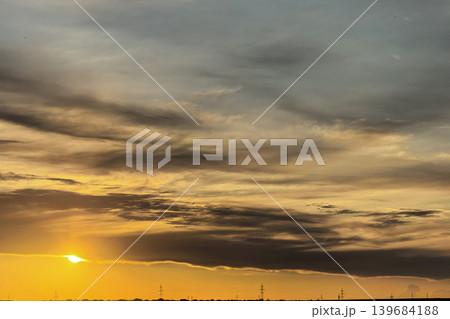 Golden Sunset Glowing Through Dark Evening Clouds Golden Sunset Glowing Through Dark Evening Clouds 139684188