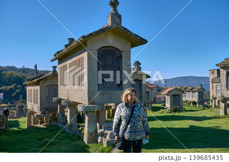 Portrait of a woman enjoying the charm of Lindoso iconic granaries in Portugal 139685435