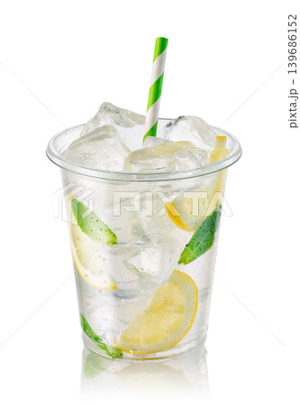Lemonade in transparent disposable plastic cup with ice, lemon slices and fresh mint leaves isolated on white background Lemonade in transparent disposable plastic cup with ice, lemon slices and fresh mint leaves isolated on white background 139686152