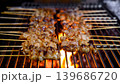 grilled pork intestines skewers on hot flames in street food market  139686720
