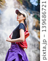 asian woman traveller relaxing in deep tropical jungle waterfall  139686721