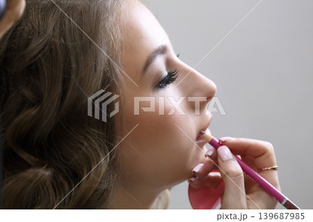 Beauty salon and makeup. Women's Hair Salon. The stylists at the women's salon are working with a young woman. Beauty salon and makeup. Women's Hair Salon. The stylists at the women's salon are working with a young woman. 139687985