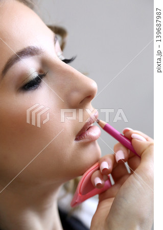 Beauty salon and makeup. Women's Hair Salon. The stylists at the women's salon are working with a young woman.  139687987