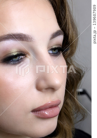 Beauty salon and makeup. Women's Hair Salon. The stylists at the women's salon are working with a young woman.  139687989