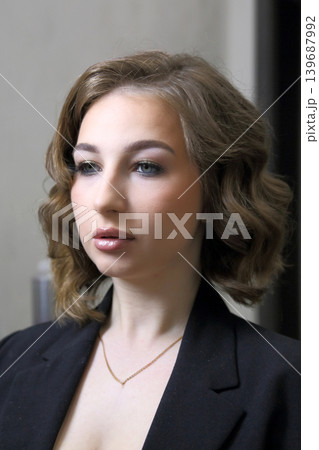 Beauty salon and makeup. Women's Hair Salon. The stylists at the women's salon are working with a young woman.  139687992