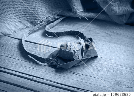 Old sling with a stone Old sling with a stone 139688680