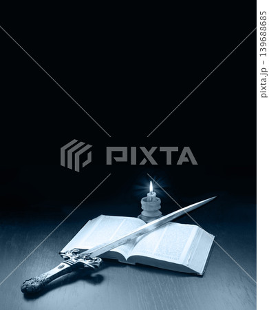 Old book and sword on the table 139688685
