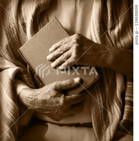 Old man holding a book Old man holding a book 139688699