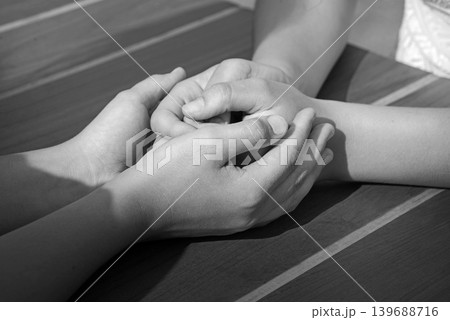 Close-up view of comforting hands 139688716