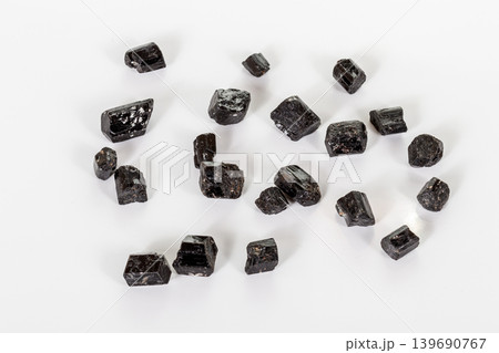 macro mineral stone schorl, black tourmaline on white background macro mineral stone schorl, black tourmaline on white background 139690767