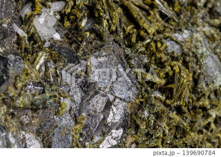 Macro mineral Epidote stone on a white background Macro mineral Epidote stone on a white background 139690784
