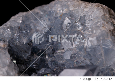 Celestine mineral stone macro on microcline on black background 139690842