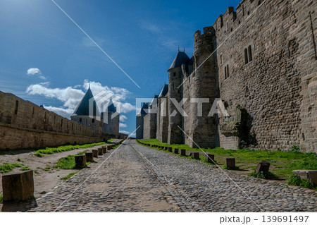 France, Medieval ramparts of the Cite de Carcassonne under a blue sky. France, Medieval ramparts of the Cite de Carcassonne under a blue sky. 139691497