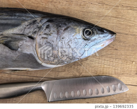 Raw Fish Head and Kitchen Knife Blade Detail Raw Fish Head and Kitchen Knife Blade Detail 139692335