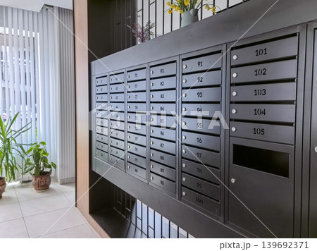 Modern metal mailboxes in an apartment building lobby 139692371