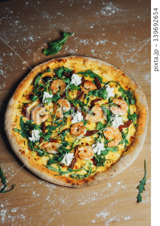 Delectable seafood pizza featuring succulent shrimp and crisp arugula Delectable seafood pizza featuring succulent shrimp and crisp arugula 139692654