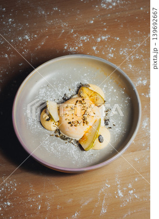Delicate chicken breast with pickled pears and herbs on a grey plate Delicate chicken breast with pickled pears and herbs on a grey plate 139692667