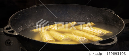 Yellow corn is cooked in a large cauldron 139693108